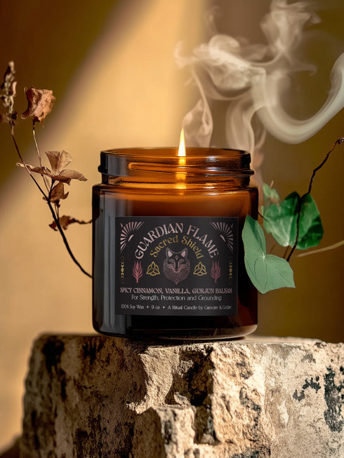 Amber glass jar with Guardian Flame label featuring a metallic wolf and flame motifs in pink and gold. Spicy cinnamon, vanilla, and gurjun balsam candle. 9 oz soy candle by Grimoire & Goblet.